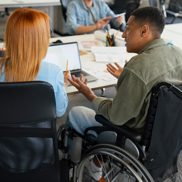 Étudiant handicapé et sa camarade de formation en train de réviser les épreuves de comptabilité