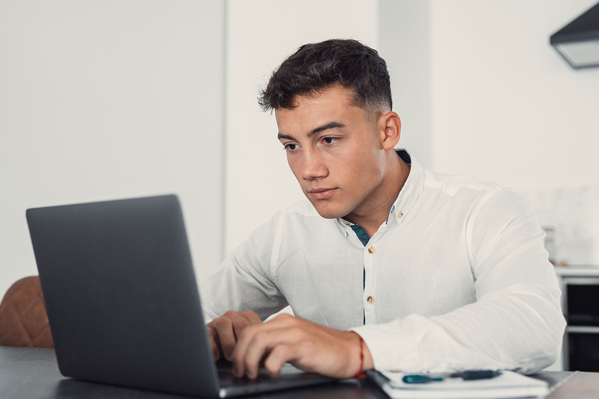 Étudiant à son bureau devant son ordinateur en train d'étudier le programme dcg 2ème année